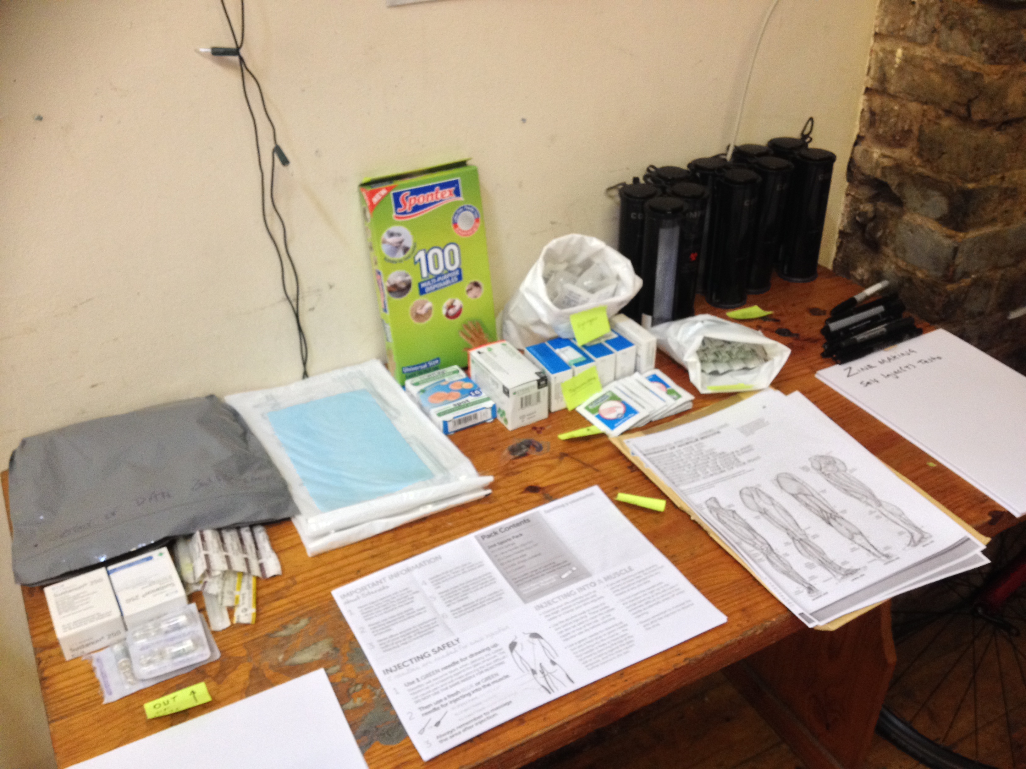 Photo of workshop materials such as cleaning wipes, printed handouts, and disposable gloves